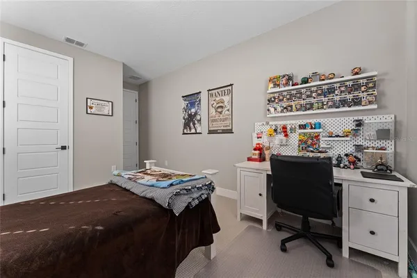 a bedroom with a bed and a desk