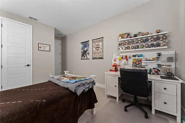 a bedroom with a bed and a desk