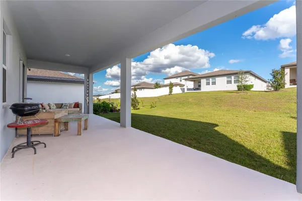 a view of a swimming pool with an outdoor seating and kitchen view