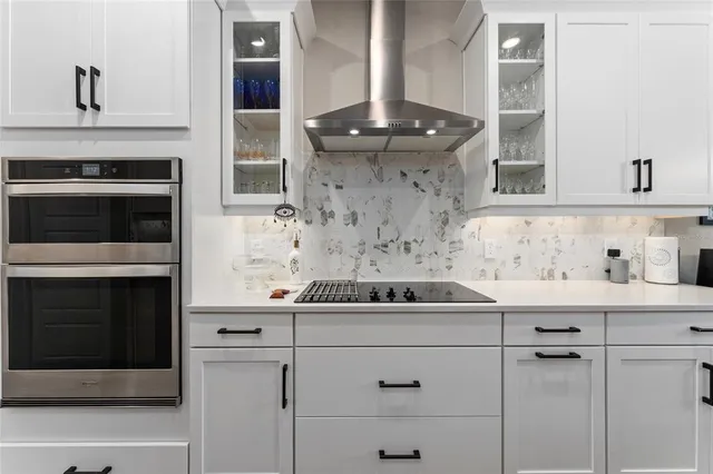 a kitchen with a sink stainless steel appliances and cabinets