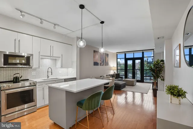 a kitchen with a table chairs stove and microwave