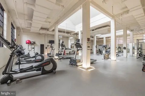 a living room with fireplace furniture and floor to ceiling window