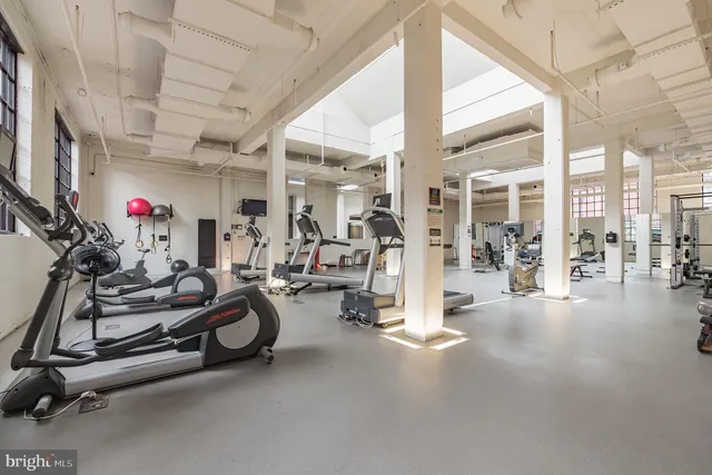 a living room with fireplace furniture and floor to ceiling window