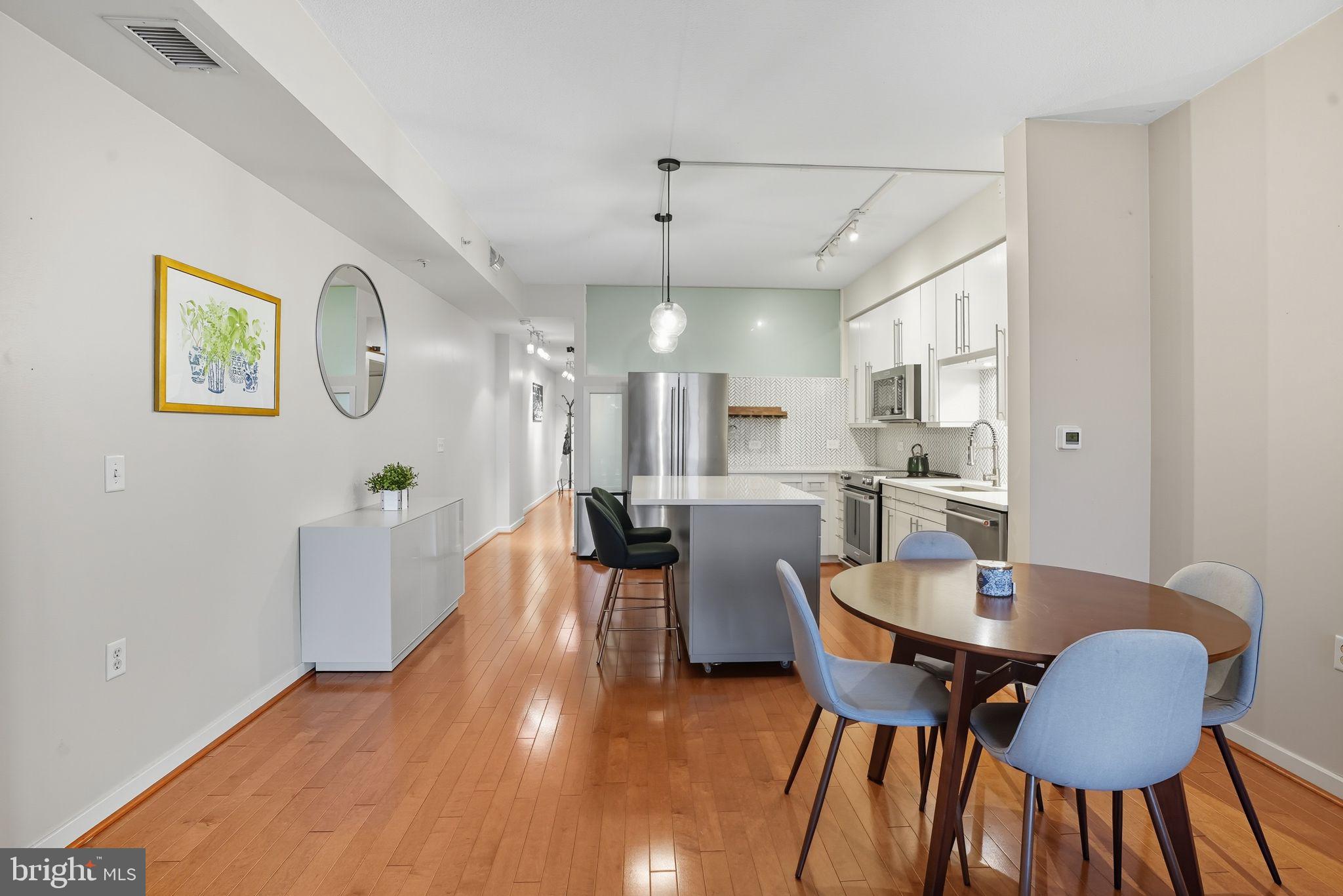 437 New York Avenue Northwest, Unit 222 Washington, DC 20001 - Photo 7 of 20 a view of a dining room with furniture and wooden floor