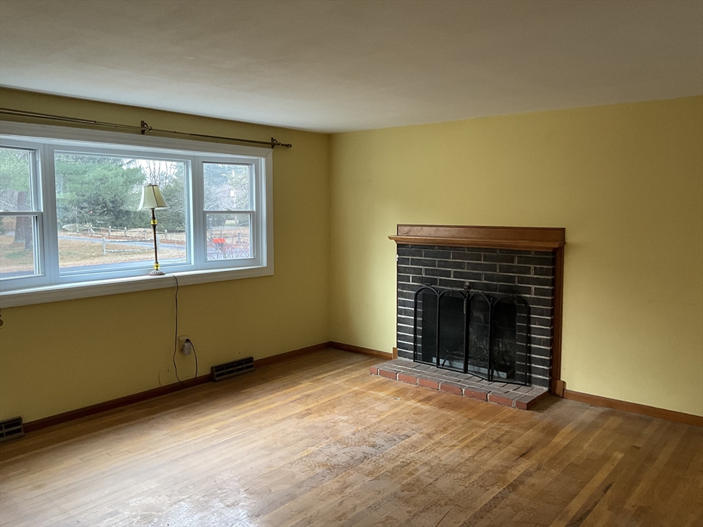 93 Plain Street Mansfield, MA 02048 - Photo 11 of 20 an empty room with a fireplace