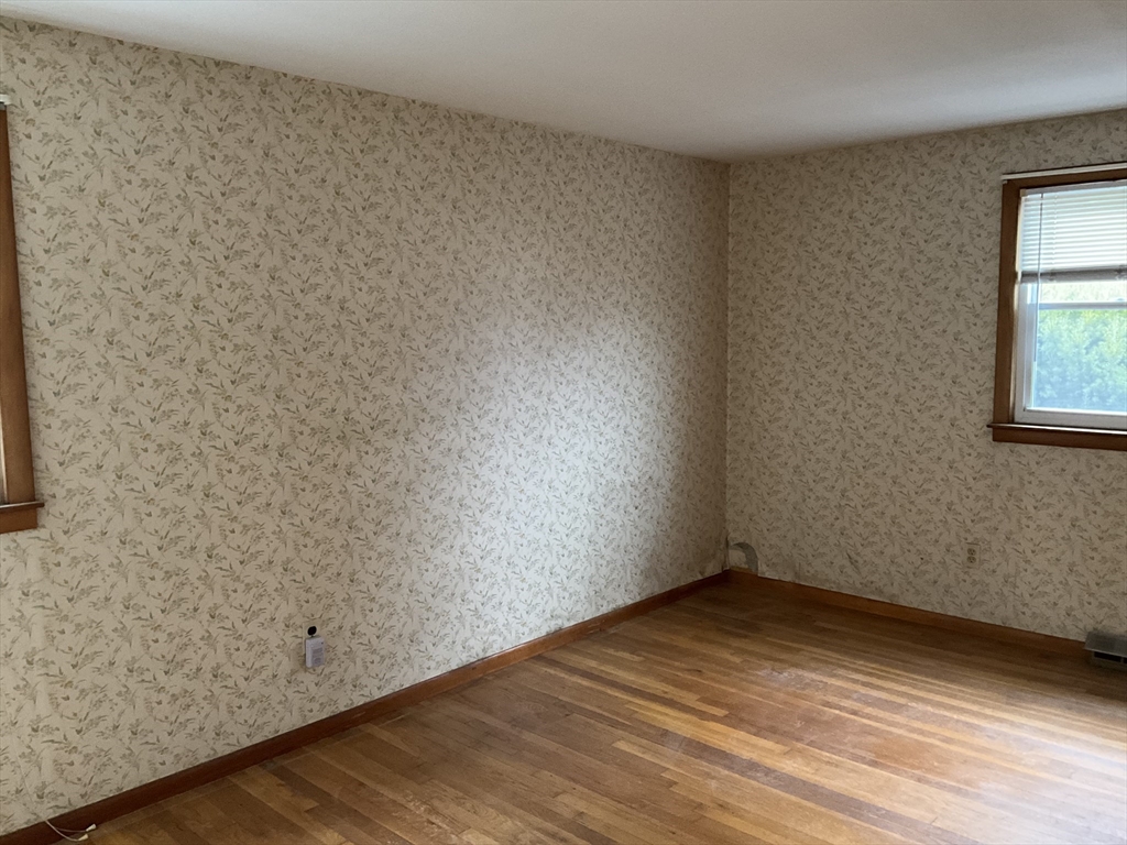 93 Plain Street Mansfield, MA 02048 - Photo 13 of 20 an empty room with wooden floor and windows