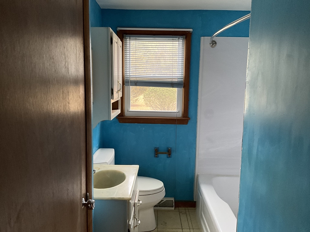 93 Plain Street Mansfield, MA 02048 - Photo 15 of 20 a bathroom with a granite countertop toilet and a sink