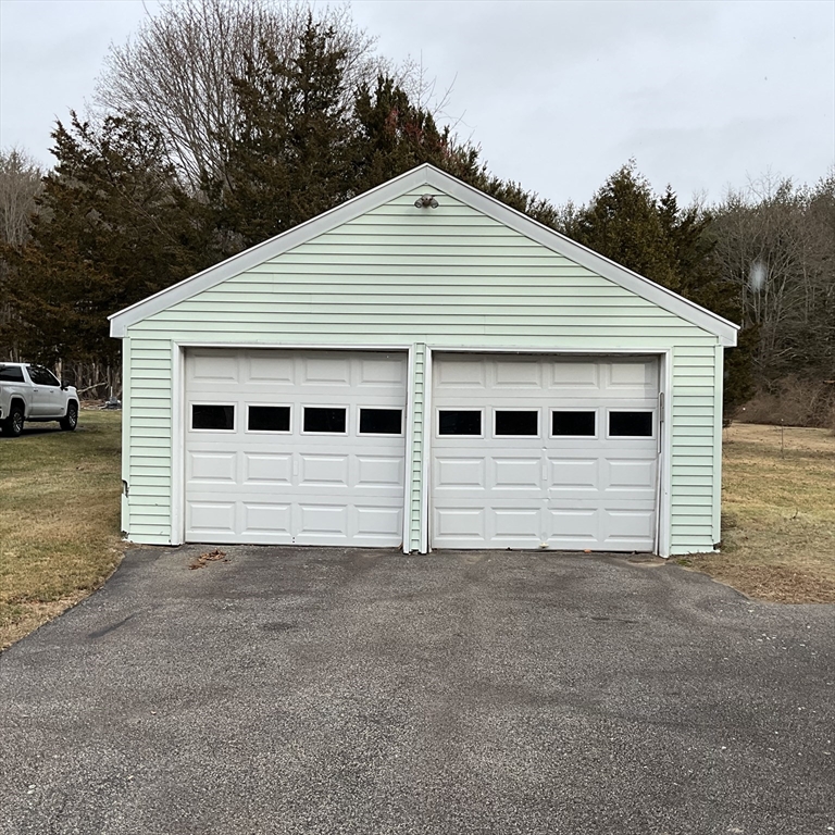 93 Plain Street Mansfield, MA 02048 - Photo 3 of 20 a view of a house with a yard and garage