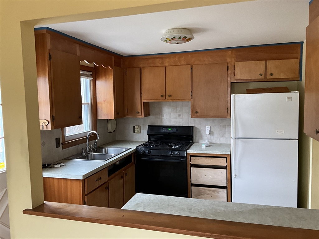93 Plain Street Mansfield, MA 02048 - Photo 8 of 20 a kitchen with a refrigerator stove and sink