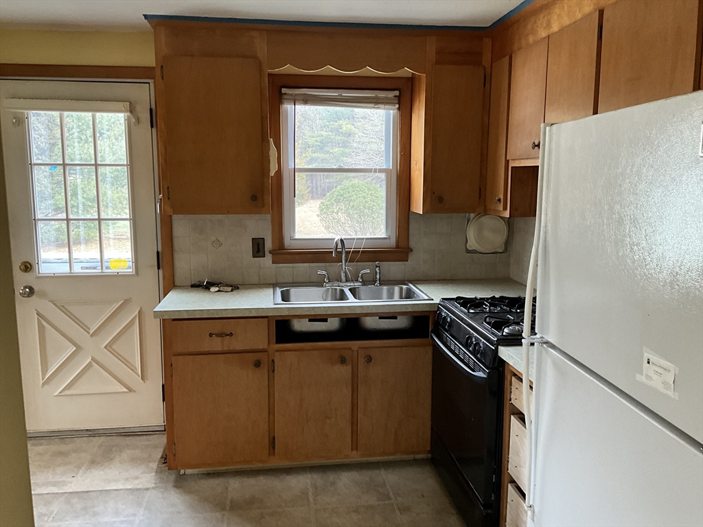 93 Plain Street Mansfield, MA 02048 - Photo 9 of 20 a kitchen with granite countertop a sink stove and refrigerator