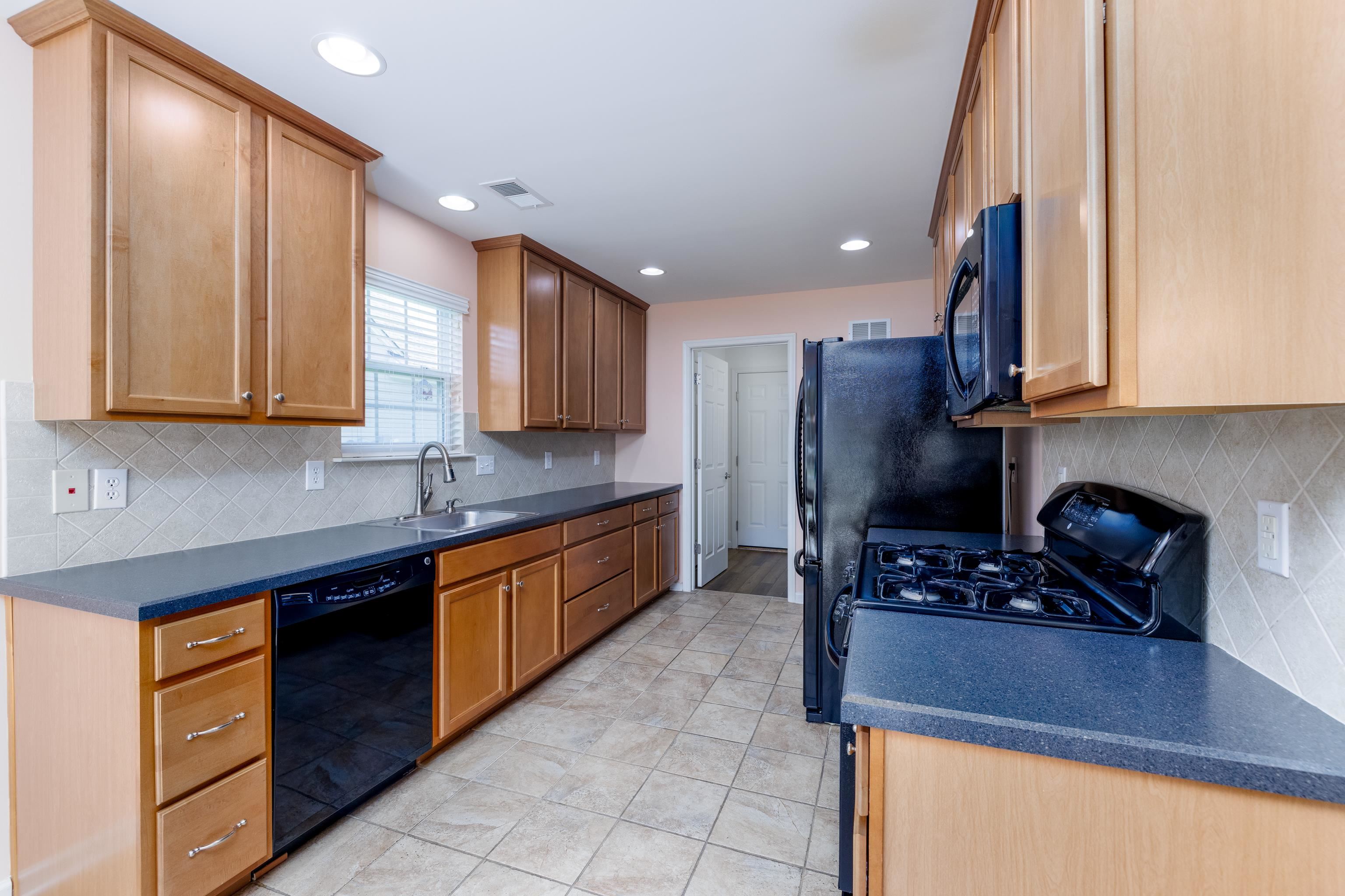 321 Aberdeen Way Rio Grande, NJ 08242 - Photo 13 of 32 a kitchen with stainless steel appliances granite countertop a stove a sink and a microwave
