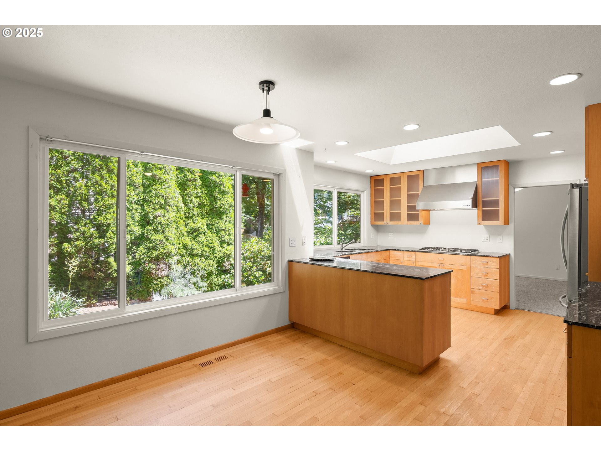 680 Northwest Torryview Lane Portland, OR 97229 - Photo 6 of 18 a living room with stainless steel appliances kitchen island furniture and a large window