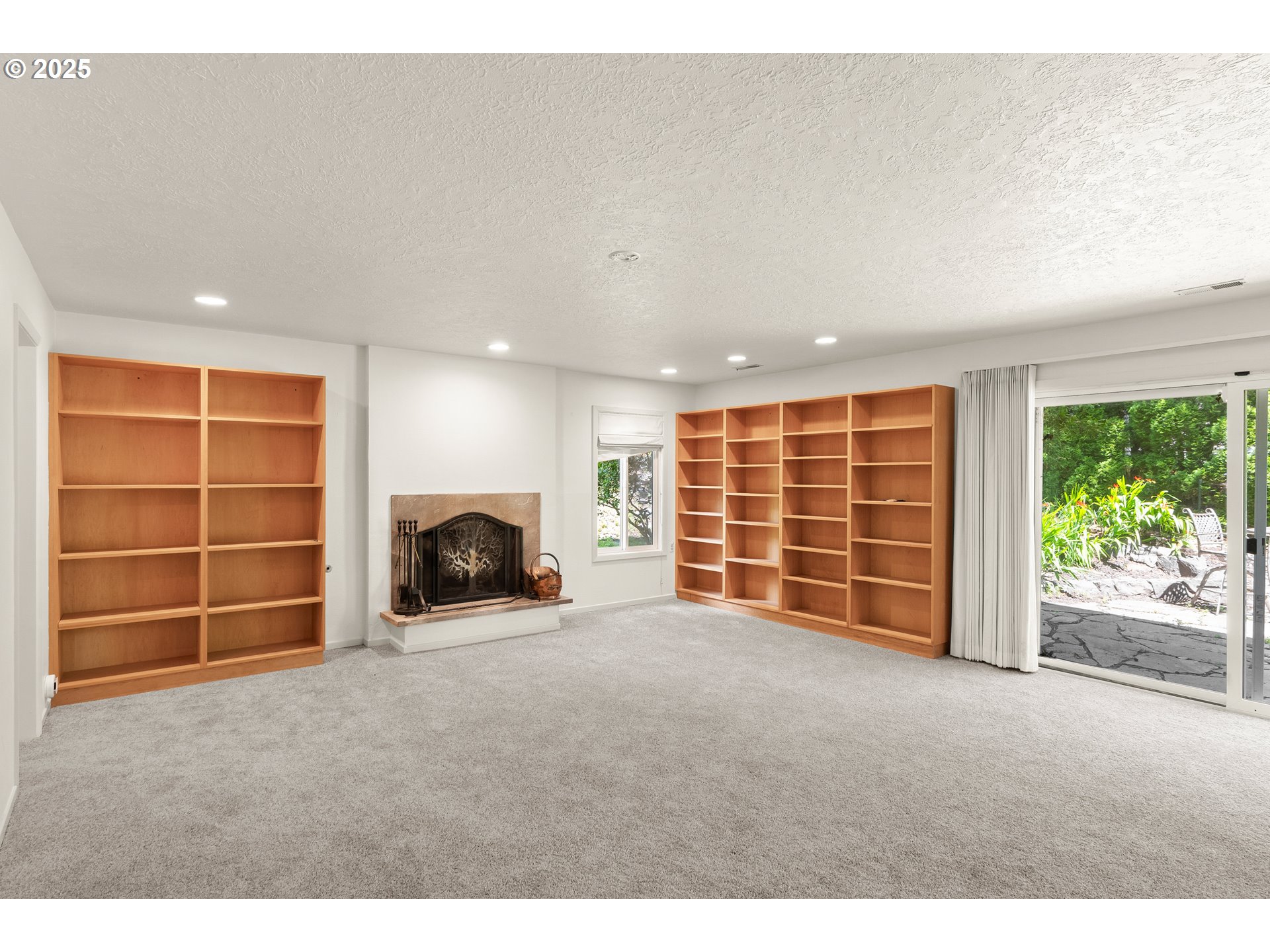 680 Northwest Torryview Lane Portland, OR 97229 - Photo 10 of 18 a view of an empty room with a fireplace and a window