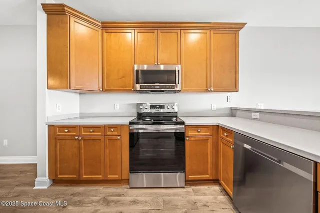 a kitchen with stainless steel appliances granite countertop a stove a sink and a microwave