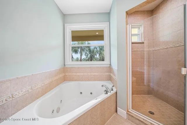 a bathroom with a bathtub and a shower