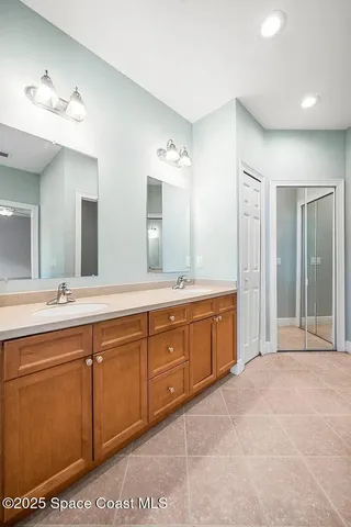 a spacious bathroom with a granite countertop sink a mirror and a