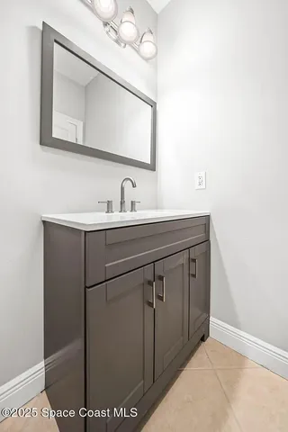 a bathroom with a sink vanity and mirror
