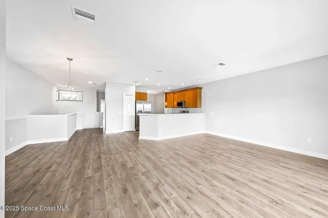 a view of kitchen and kitchen with wooden floor