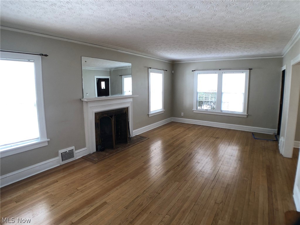 3694 Avalon Road Cleveland, OH 44120 - Photo 2 of 30 Huge living room with hardwood floors, fireplace & doors to the enclosed sun porch