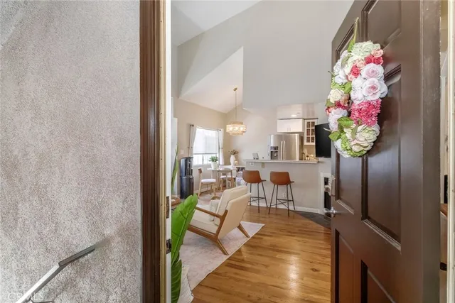 a living room with furniture flowerpot and a chandelier