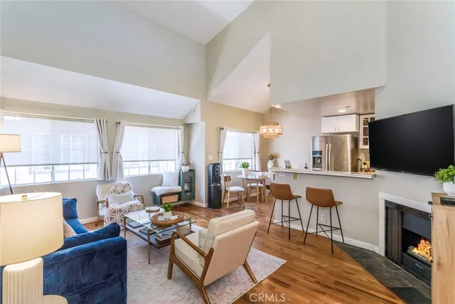 a living room with fireplace furniture and a flat screen tv