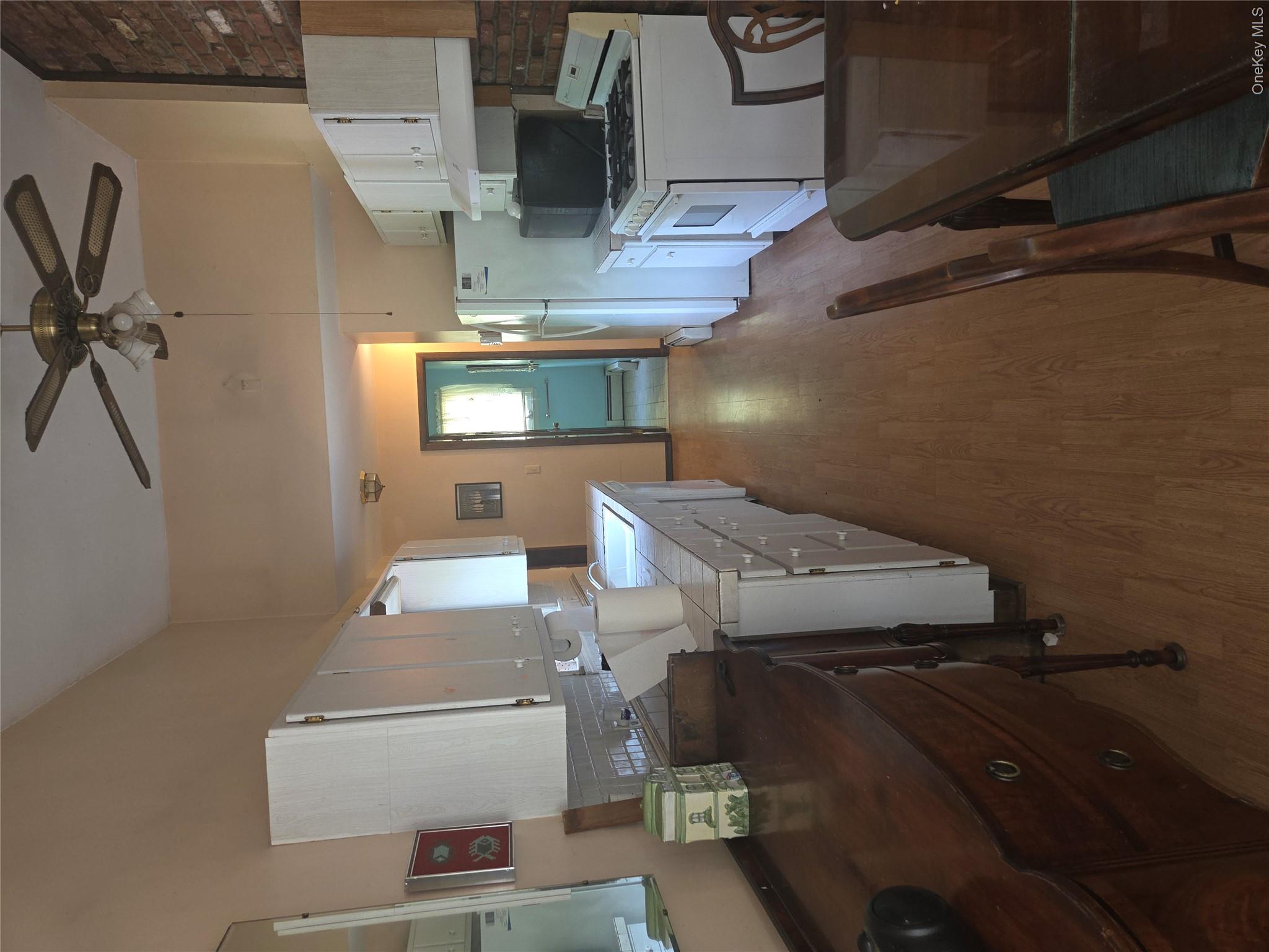 63 Otens Road Ellenville, NY 12428 - Photo 8 of 32 a kitchen with a table chairs refrigerator and cabinets