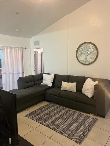 a living room with a couch and a chandelier