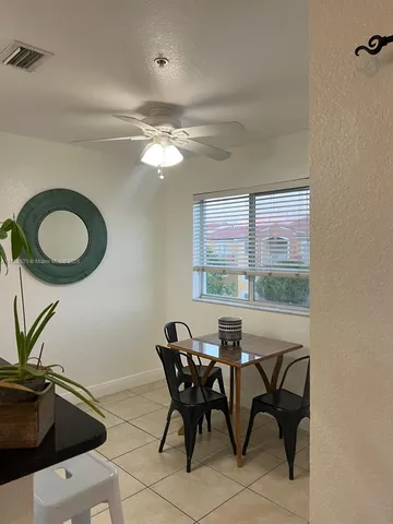 a view of a dining room with furniture window and outside view