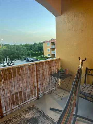 a view of balcony with wooden floor and fence