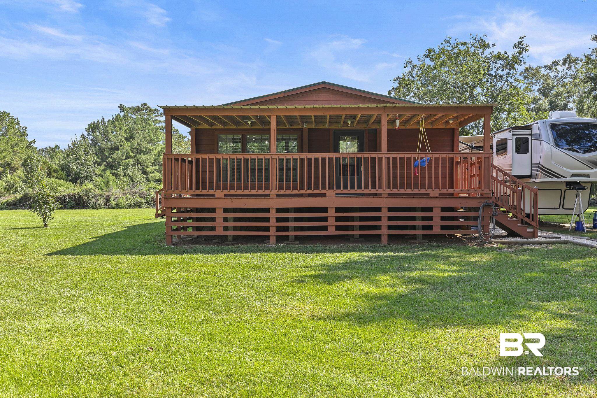 35641 County Road 39 Stapleton, AL 36578 - Photo 5 of 46 Rear view of house featuring a wooden deck and a yard