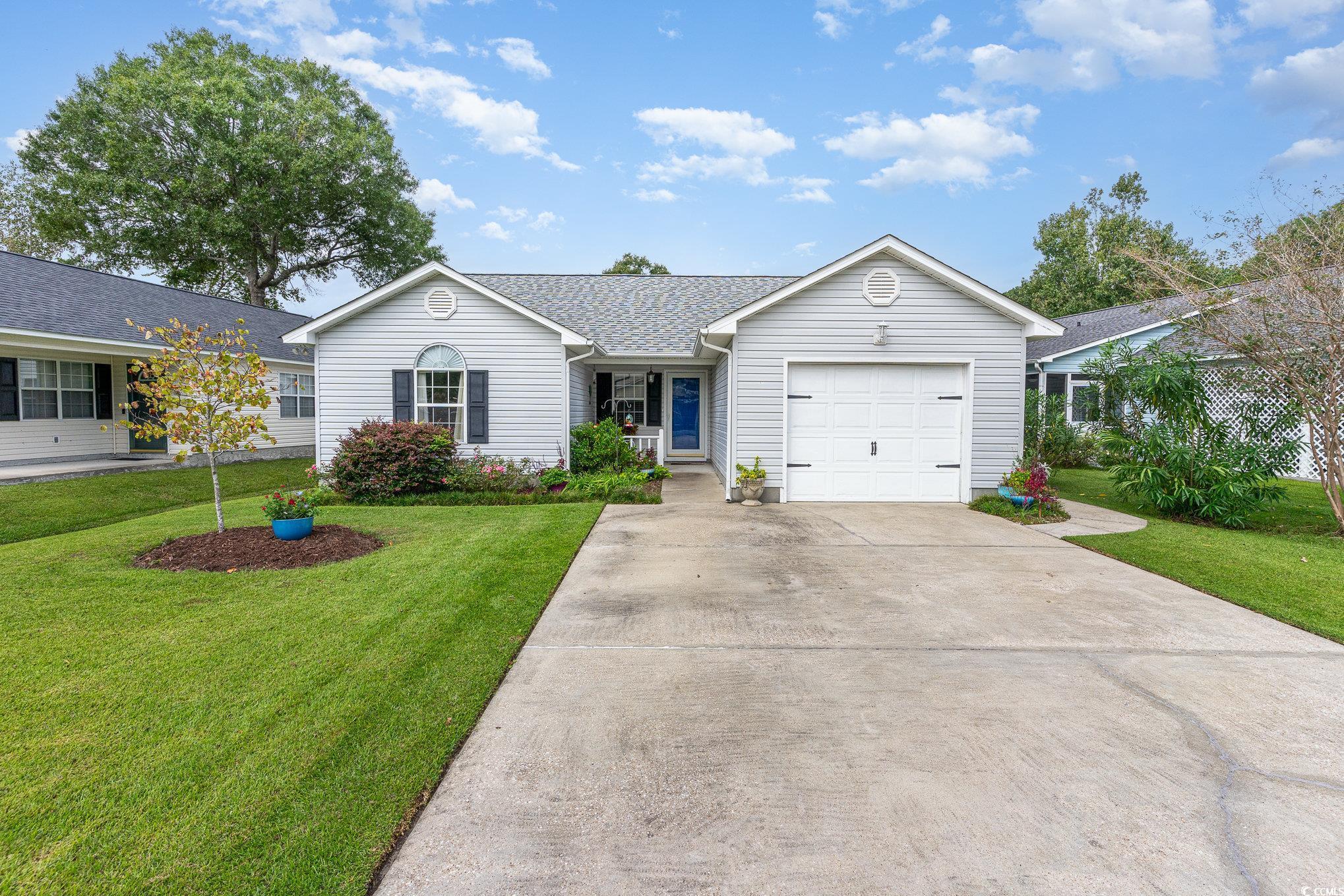 7966 Spruce Lane Murrells Inlet, SC 29576 - Photo 1 of 31 Single story home featuring a front yard and a gar