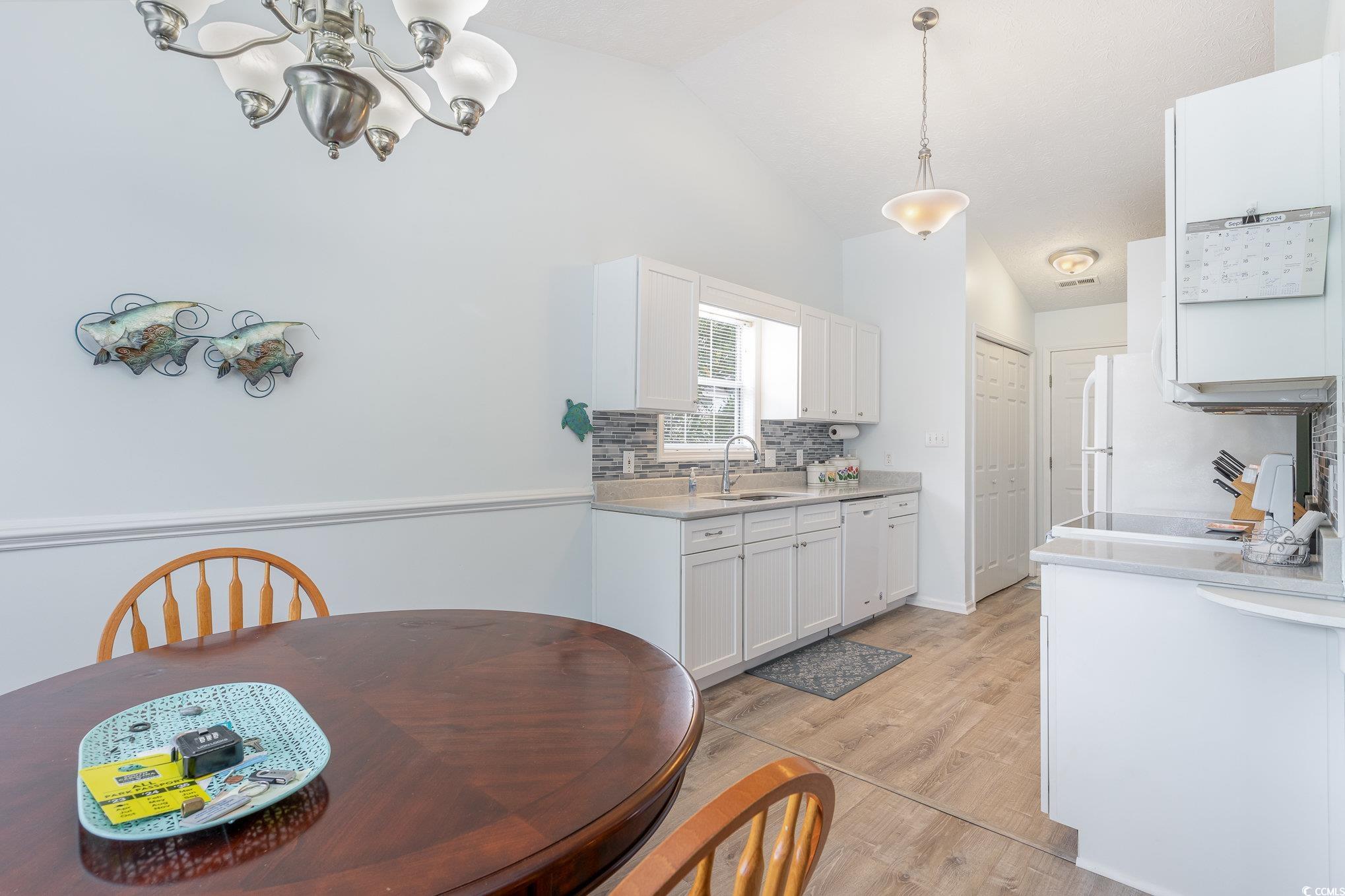 7966 Spruce Lane Murrells Inlet, SC 29576 - Photo 11 of 31 Kitchen with hardwood / wood-style flooring, sink,