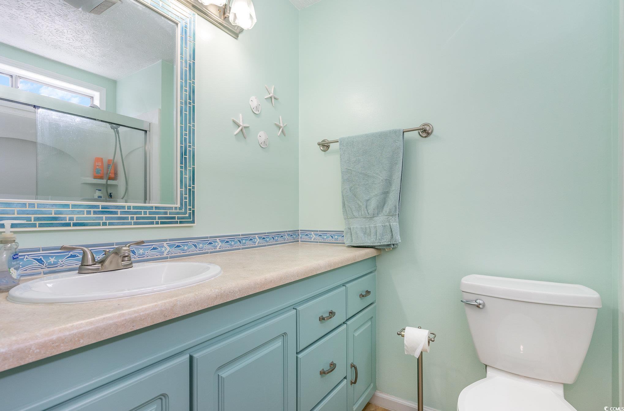 7966 Spruce Lane Murrells Inlet, SC 29576 - Photo 20 of 31 Bedroom with a textured ceiling, ceiling fan, and