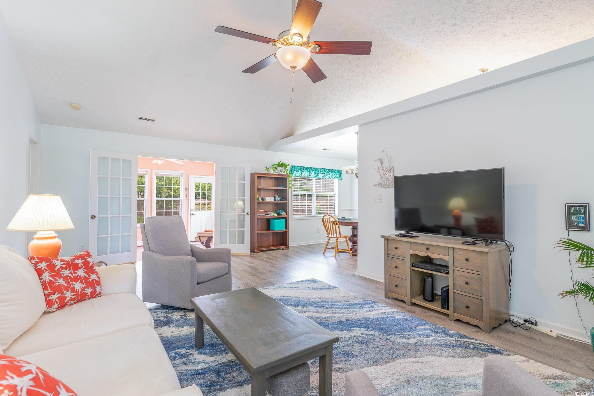 7966 Spruce Lane Murrells Inlet, SC 29576 - Photo 6 of 31 Living room featuring lofted ceiling, ceiling fan,