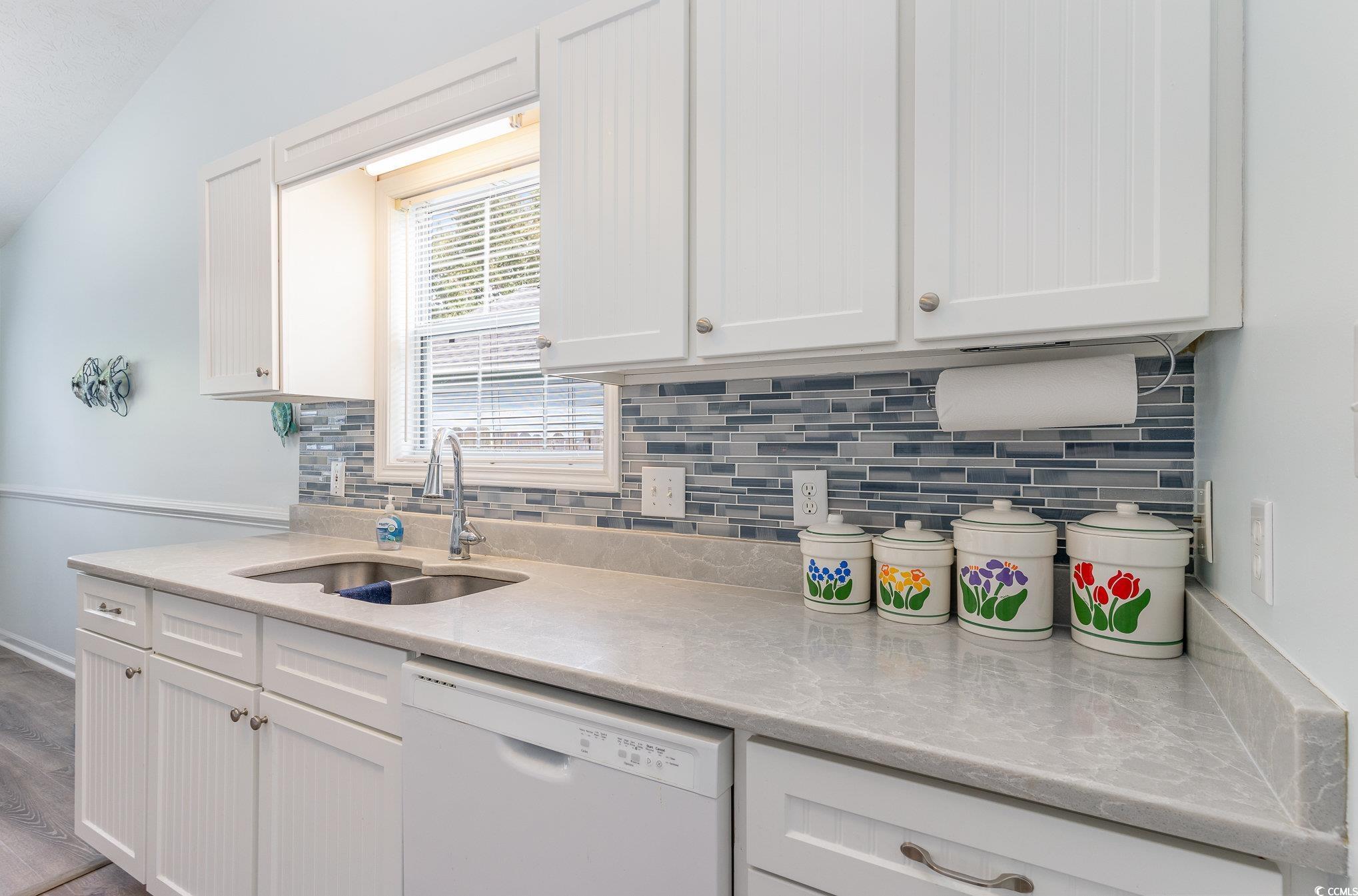 7966 Spruce Lane Murrells Inlet, SC 29576 - Photo 10 of 31 Kitchen with white cabinets, backsplash, white app