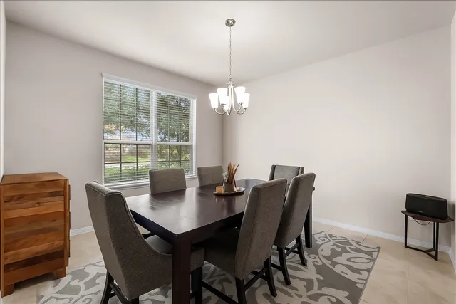 a view of a dining room with furniture and chandelier