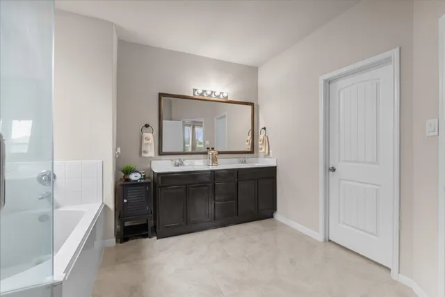 a bathroom with a tub and shower