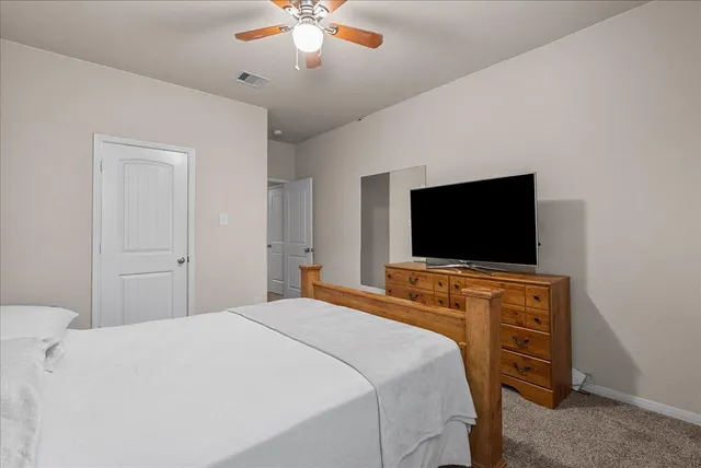 a bedroom with a bed and a dresser