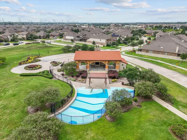 an aerial view of a house with a garden and lake view