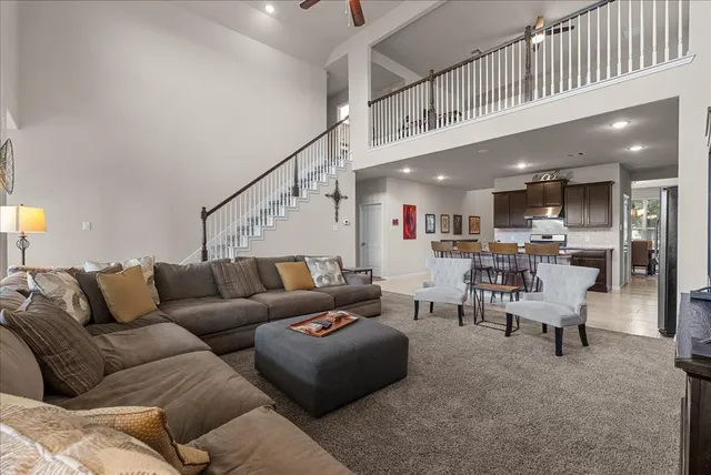 a living room with furniture and kitchen view