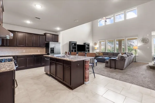 a spacious kitchen with a stove and a sink