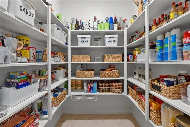 a kitchen with stainless steel appliances granite countertop a stove top oven a sink dishwasher a dining table and chairs with wooden floor