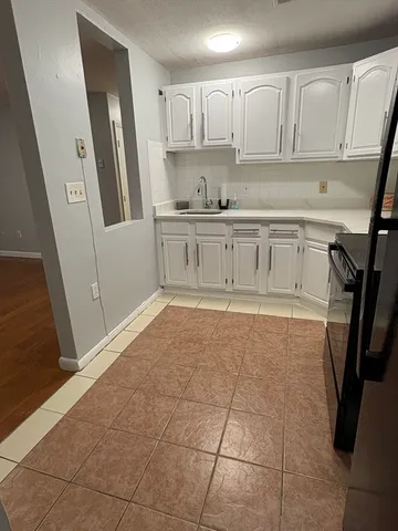 a kitchen with stainless steel appliances a refrigerator and cabinets