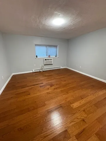 a view of a kitchen with wooden floor and cabinets