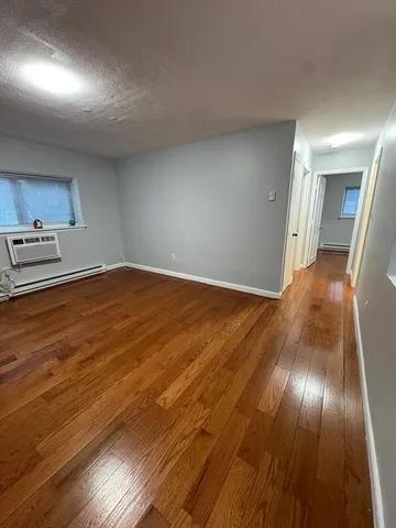 a view of an empty room and wooden floor