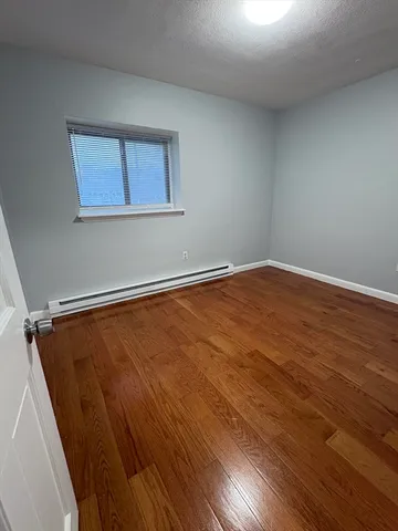 a view of a room with wooden floor and window