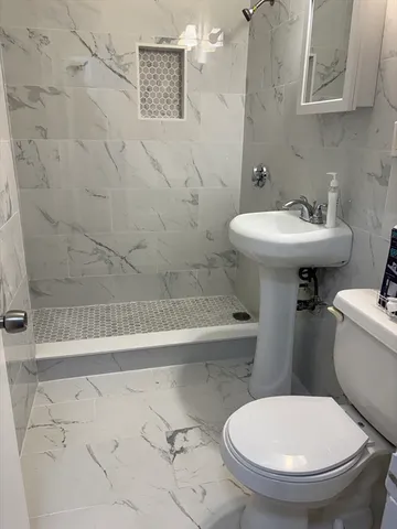 a white toilet sitting next to a bathroom sink