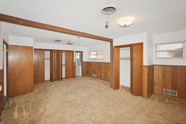 an empty room with closet area
