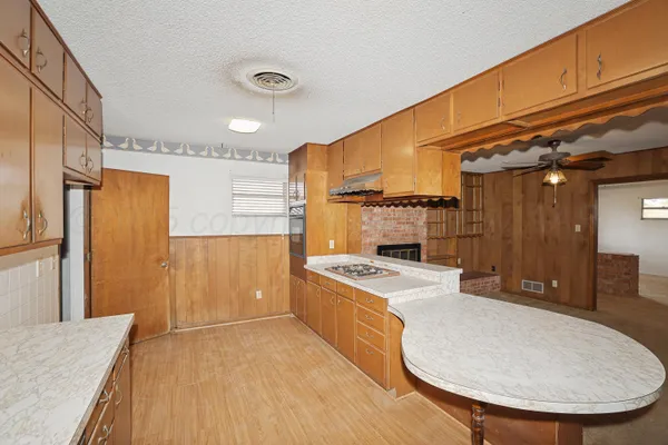 a kitchen with a stove a refrigerator and a sink