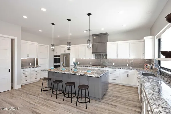 a bathroom with a granite countertop sink a large mirror and shower